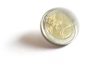 A spinning coin, about to fall on tails